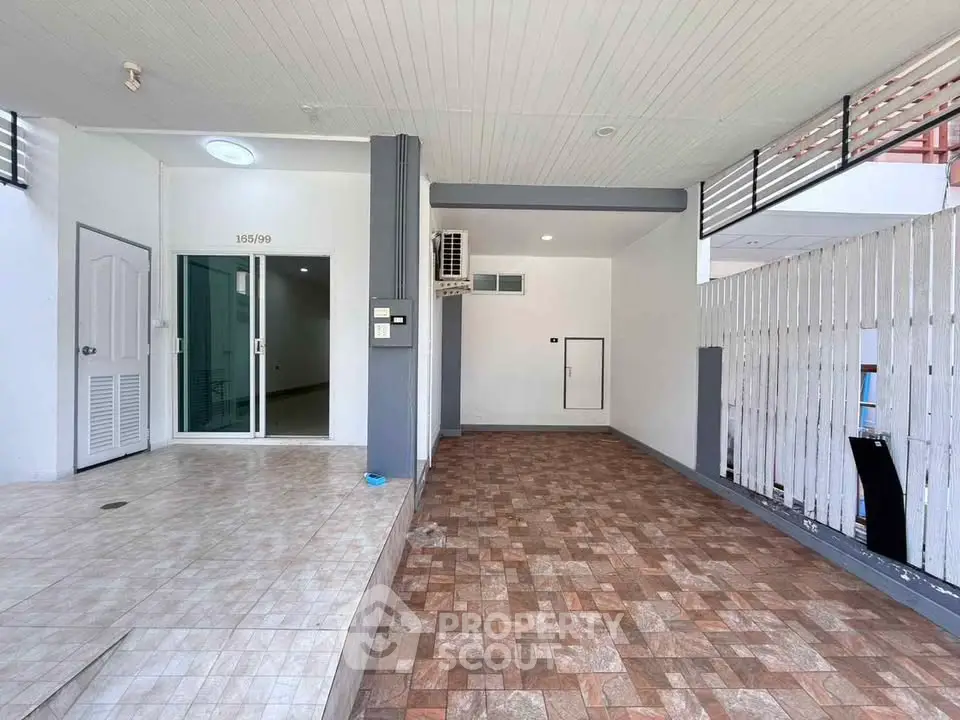 Spacious modern home entrance with tiled flooring and sleek design