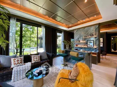 Luxurious living room with modern decor, large windows, and stylish furniture overlooking a lush garden.