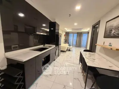 Modern open-layout kitchen and living room with sleek design and marble flooring