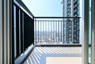 Modern high-rise balcony with cityscape view, perfect for urban living.