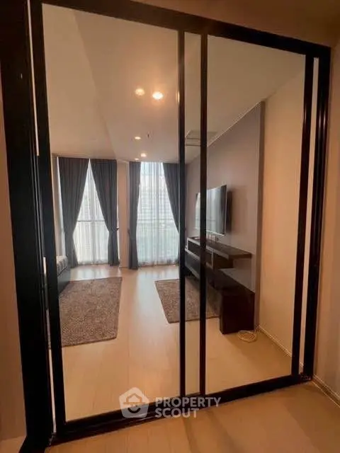 Modern living room with sleek design and large windows offering ample natural light.