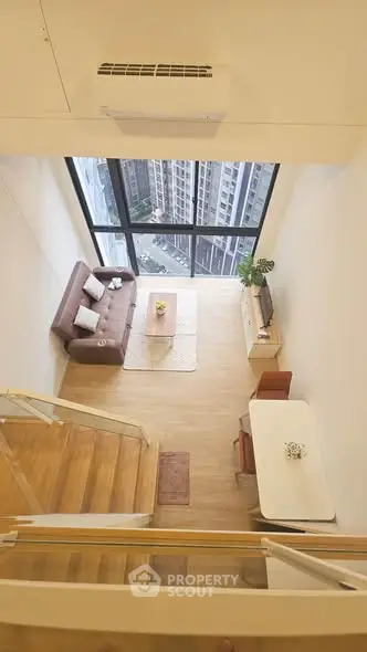 Stunning loft apartment with high ceilings and city view, featuring modern living room and dining area.
