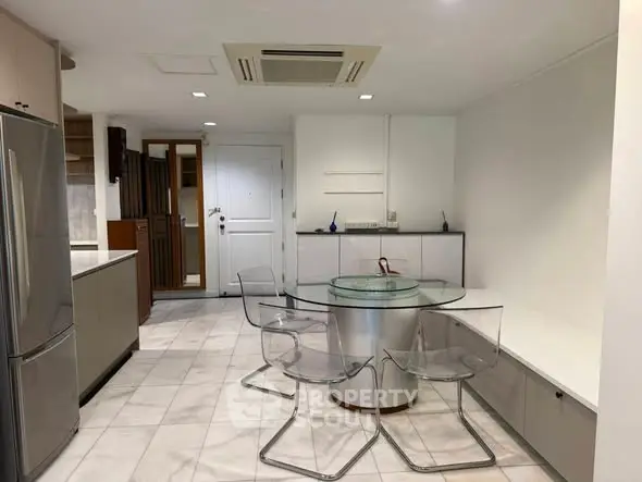 Modern kitchen with sleek design and glass dining table in open layout