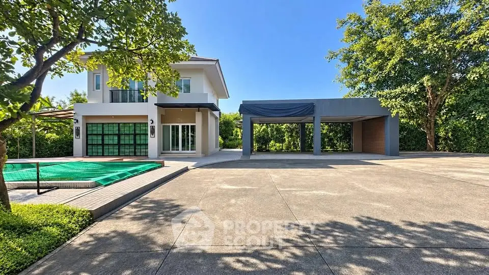 Modern two-story house with spacious driveway and lush greenery