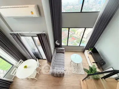 Modern loft living room with high ceilings and panoramic city views.