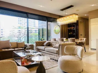 Luxurious living room with elegant furniture and stunning city view through large windows.