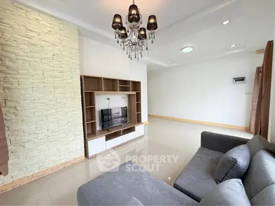 Spacious living room with modern chandelier and stylish entertainment unit