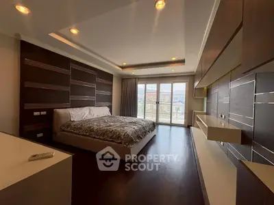 Luxurious bedroom with modern design and large windows offering natural light.