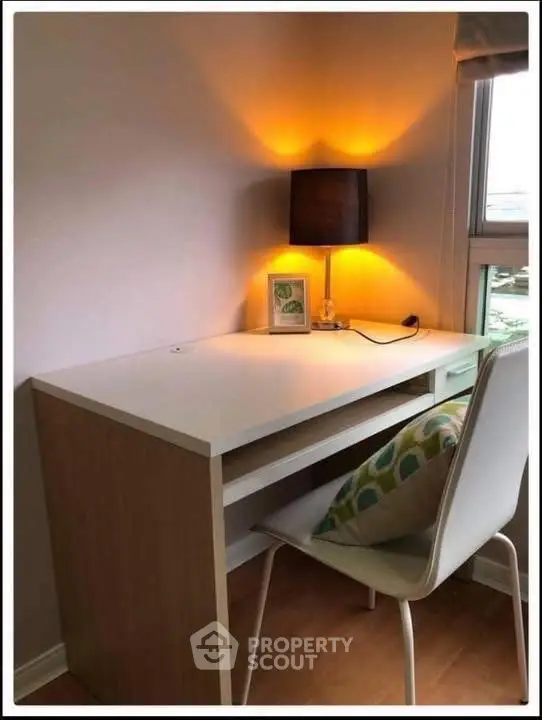 Cozy study nook with modern desk and ambient lighting in a bright corner.
