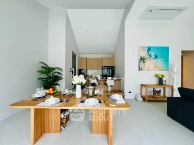 Modern dining area with elegant table setting and open kitchen layout in a stylish apartment.