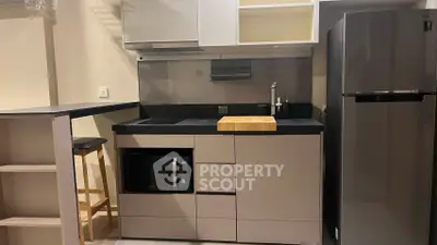 Modern compact kitchen with sleek cabinetry and stainless steel appliances