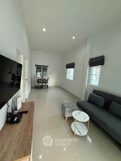 Spacious modern living room with sleek furniture and natural light