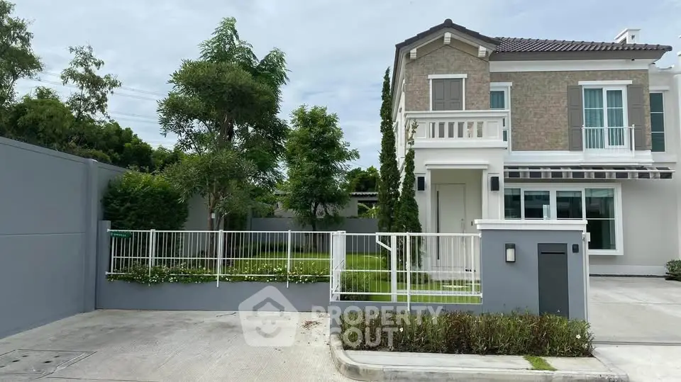 Charming two-story house with lush garden and modern exterior design in a serene neighborhood.