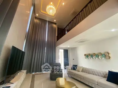 Luxurious high-ceiling living room with elegant chandelier and modern decor