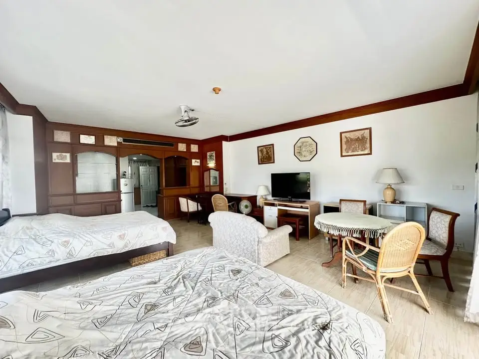 Spacious bedroom with cozy seating area and modern amenities