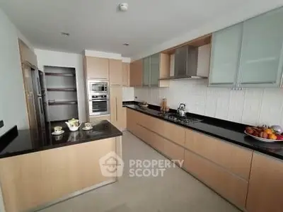 Modern kitchen with sleek cabinetry and built-in appliances, featuring a gas stove and ample counter space.