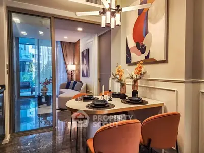 Stylish dining area with modern decor and open layout leading to cozy living room.