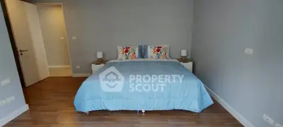 Cozy bedroom with blue bedding and wooden flooring