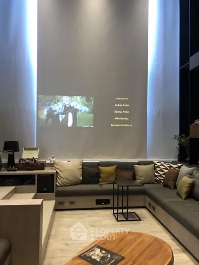 Stylish modern living room with cozy seating and home theater setup