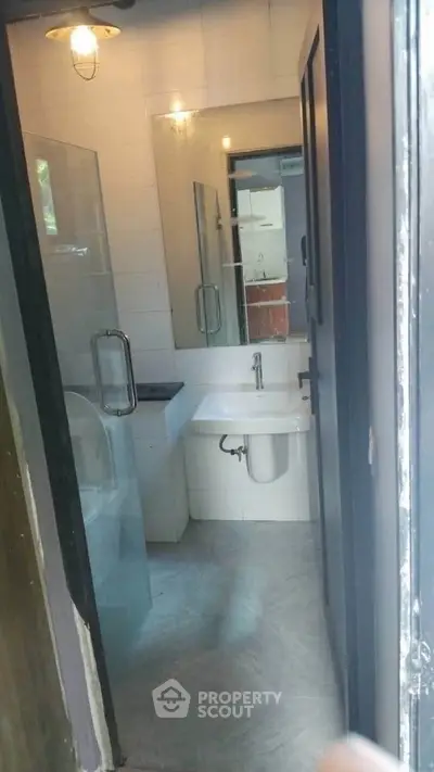 Compact modern bathroom with glass shower and sleek fixtures