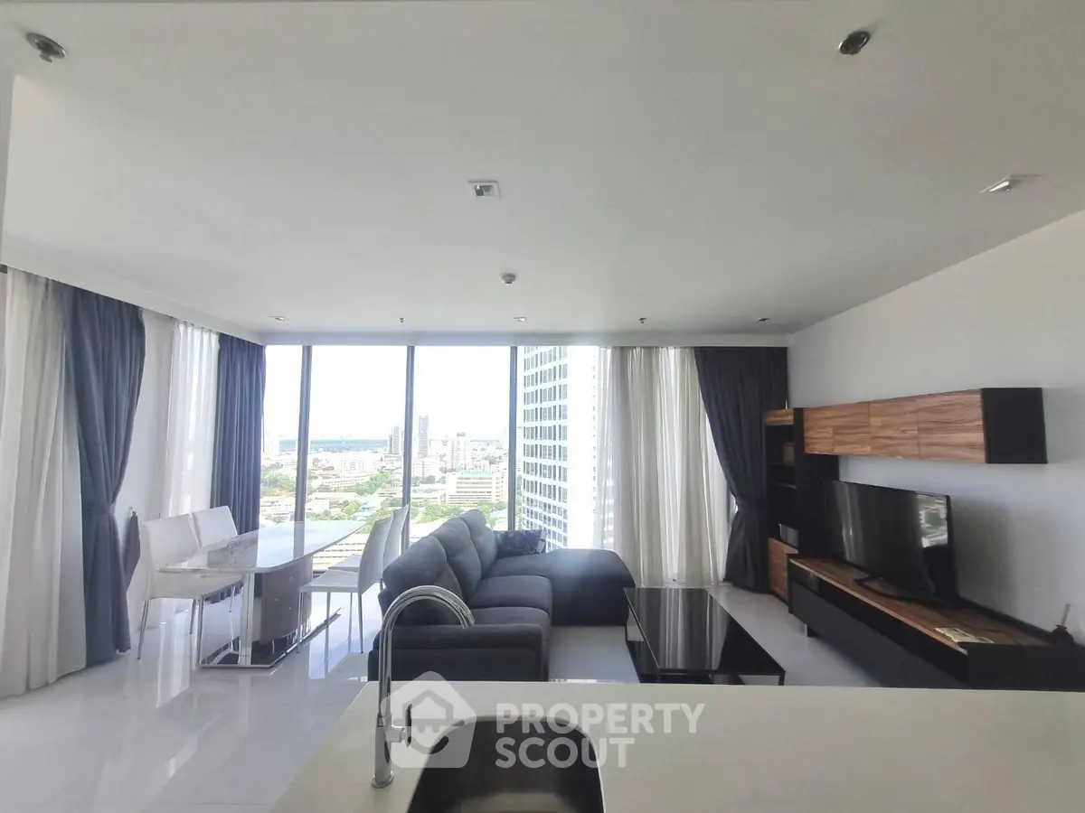 Spacious modern living room with panoramic city views and elegant furnishings