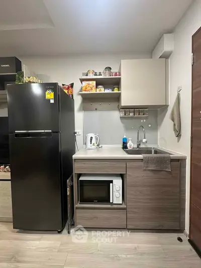 Modern compact kitchen with sleek appliances and stylish cabinetry