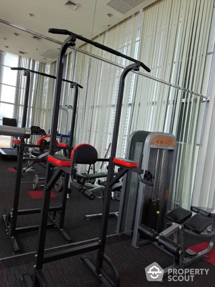 Modern gym with state-of-the-art fitness equipment and floor-to-ceiling windows.