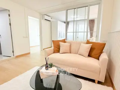 Stylish living room with cozy sofa and modern decor in bright apartment.