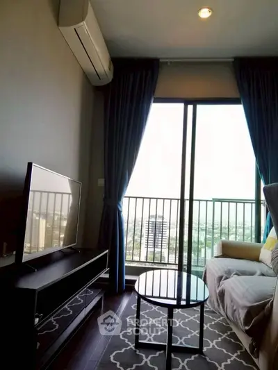 Modern living room with large window and city view, featuring a cozy sofa and sleek TV setup.