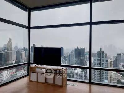 Stunning high-rise living room with panoramic city views and modern decor.