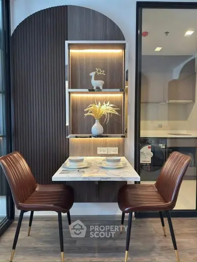 Stylish dining nook with modern chairs and decorative shelving in a contemporary apartment.