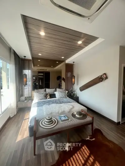 Luxurious bedroom with modern decor, wooden ceiling, and large windows for natural light.
