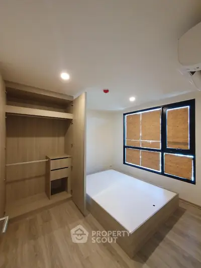 Modern minimalist bedroom with built-in wardrobe and natural light