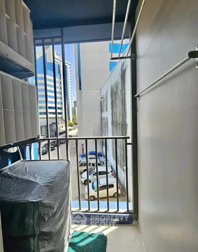 Urban balcony view with cityscape and parked cars, ideal for compact living spaces.