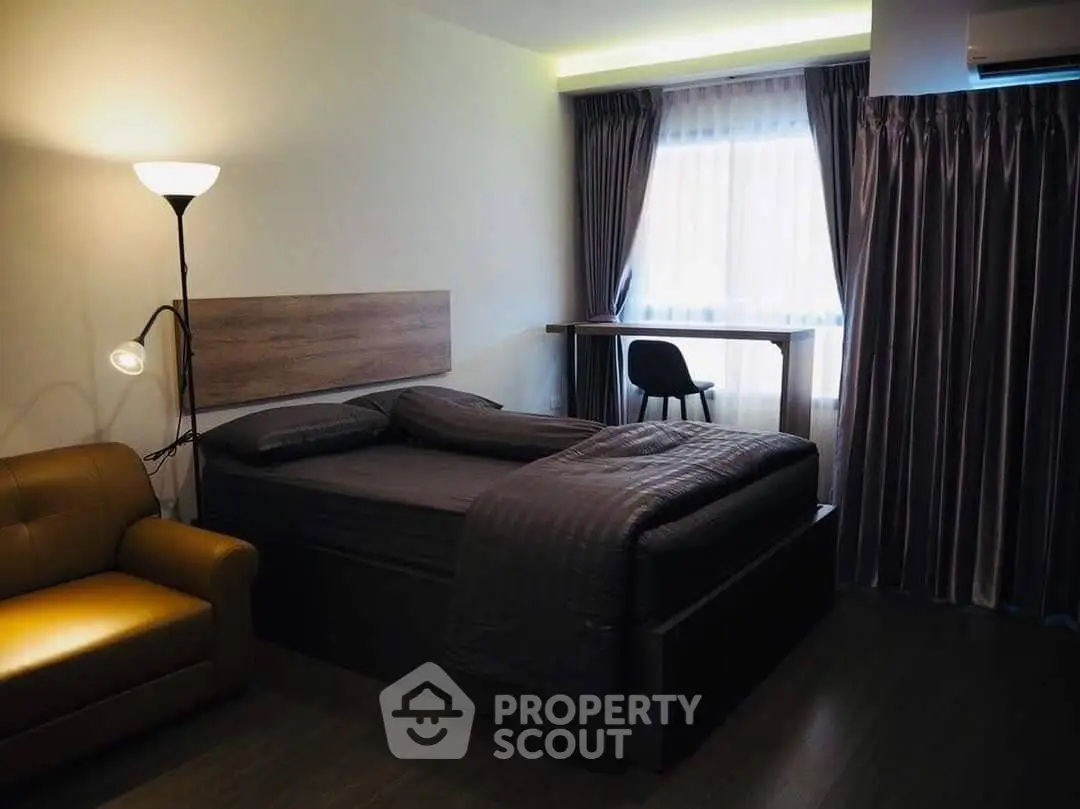 Cozy bedroom with modern furnishings and ample natural light