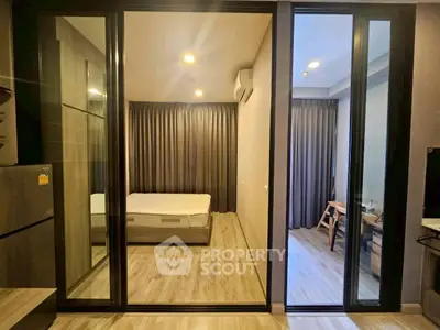 Modern apartment interior with bedroom and study area, featuring sleek design and ample natural light.