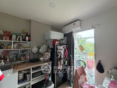 Cozy kitchen with open shelving and balcony view, featuring modern appliances and ample natural light.