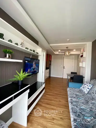 Modern living room with stylish decor and wooden flooring in a cozy apartment.