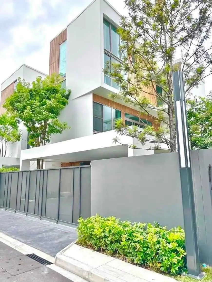 Modern architectural townhouse with sleek design and lush greenery