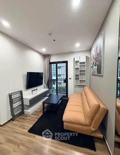 Modern living room with sleek design, featuring a cozy sofa, wall-mounted TV, and stylish decor.