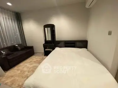 Cozy bedroom with modern furniture and soft lighting, perfect for relaxation.