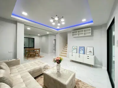Modern living room with elegant lighting and stylish furniture in a spacious open layout.