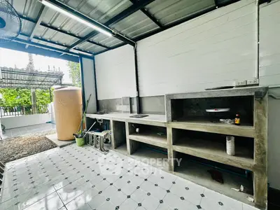 Spacious outdoor kitchen with modern concrete countertops and ample storage space