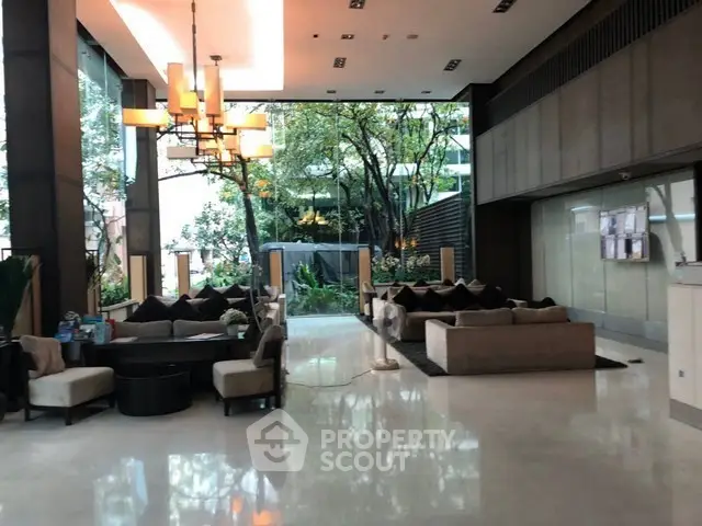 Luxurious modern lobby with elegant seating and lush greenery views