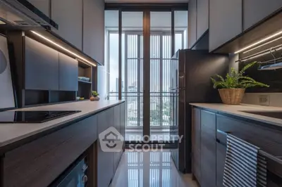 Modern kitchen with sleek cabinetry and large window view