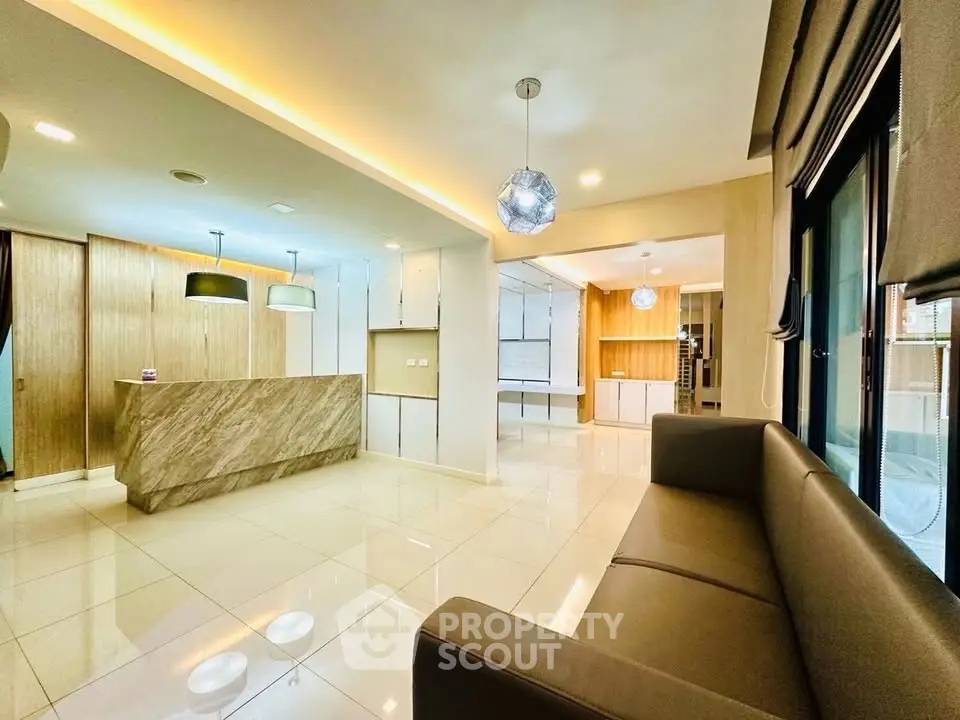 Spacious modern living area with elegant lighting and sleek design.