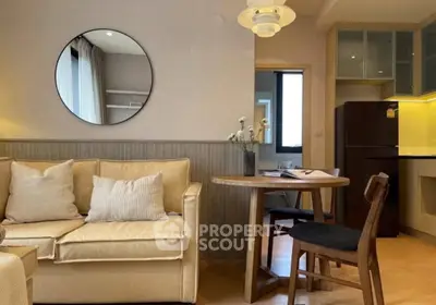Charming living room with cozy sofa, round mirror, and stylish dining area in modern apartment.