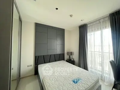 Modern bedroom with stylish decor and large window for natural light.