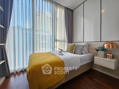Modern bedroom with floor-to-ceiling windows and stylish decor