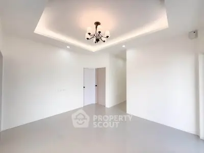 Spacious modern living room with elegant ceiling light and minimalist design